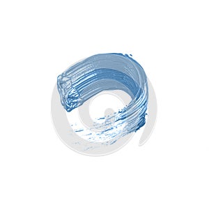 A smear of blue acrylic paint on a white isolated background