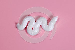 Smear of body or face cream on pink background, skin care concept