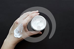 Smear cream on woman hand. Lotion for face or body