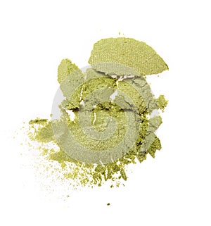 Smear of crushed green eyeshadow as sample of cosmetic product