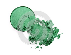 Smear of crushed green eyeshadow as sample of cosmetic product