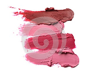 Smears of bright lipsticks on white background, top view