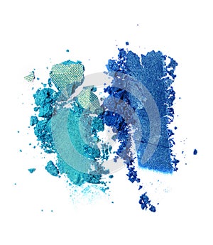 Smears of crushed teal and blue shiny eyeshadow as sample of cosmetic product