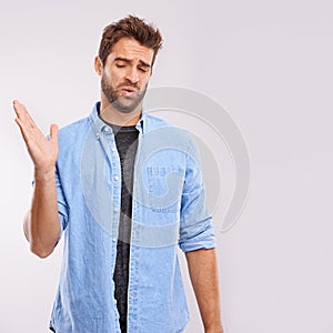 Smell, man and waving his hands for bad stink, poor hygiene and negative aroma on white studio background. Face, person