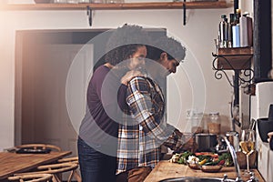 Smells good. a couple preparing a meal together in the kitchen.