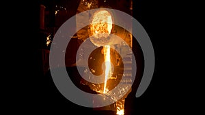 Smelting works at plant. Scene. Jet of alloy is poured out and sparks are carried in different directions at smelter