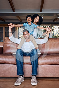 Smile, airplane and portrait with family on sofa for happy, bonding or peace on holiday. Love, care and playful with