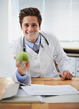 Smile, apple and portrait of man doctor with stethoscope for positive, good and confident attitude. Happy, pride and