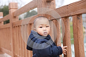 Smile Asia Chinese adorable cute toddler baby boy son child stand on bridge have fun enjoy sunny outdoor carefree nature spring