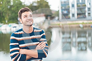 Smile beautiful cheerful man in front of river thinking positiv