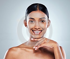 Smile, beauty and Indian woman or model with skincare cosmetic isolated in a studio white background. Clean, natural and