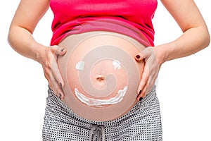 smile on belly of pregnant woman, photo close up