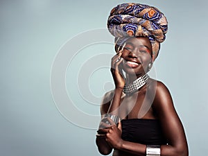 Smile, black woman and portrait with African head wrap and beauty in a studio. Isolated, grey background traditional