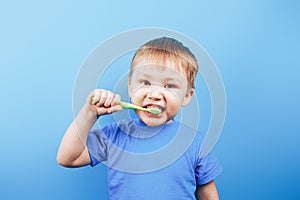 Smile boy cleans a teeth with toothbrush