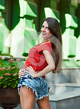 Smile brunette woman. sunlight city portrait