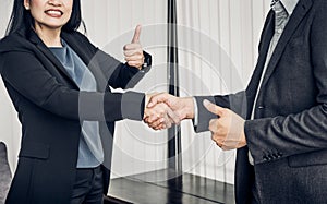 Smile Business woman and business man shaking hand and thumb up