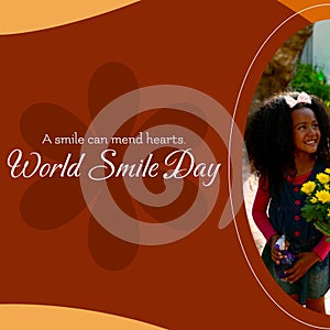 A smile can mend hearts world smile day text and biracial girl smiling