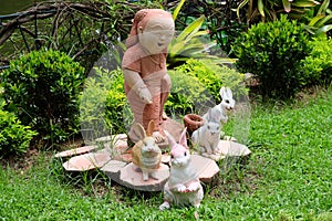 Smile child and rabbits in a garden or park