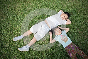 Smile children lie down on grass