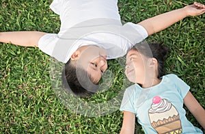 Smile children lie down on grass