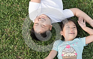 Smile children lie down on grass
