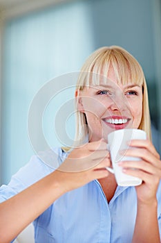 Smile, coffee and young woman at her home relaxing on a weekend morning for calm mindset. Happy, mug and female person