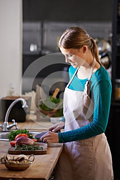 Smile, cooking and chef with vegetables in kitchen cutting ingredients with knife at home. Happy, groceries and portrait