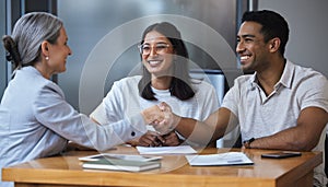 Smile, couple and handshake with financial consultant for deal, agreement or contract. Happy, man and woman shaking