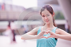 Smile cute asian girl teen love heart hand sign
