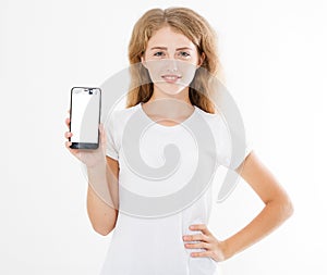 Smile cute girl, woman in tshirt hold blank screen cell phone isolated on white background. Arm holding smartphone, copy space