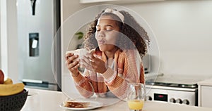 Smile, eating and kid with sandwich in kitchen for nutrition, child development and healthy diet. Hungry, little girl