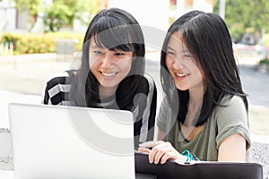 Smile, education and students with a laptop on campus for research, studying and project together. College, Asian and