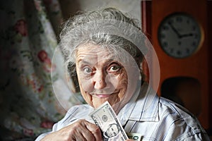 Smile elderly woman with dollars
