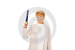 Smile elderly woman pointing up with hege pen