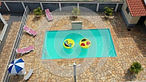 Smile emoji icon floating at swimming pool at countryside