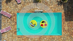 Smile emoji icon floating at swimming pool at countryside