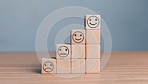 Smile face in bright side and sad face in dark side on wooden block cube for positive mindset selection concept