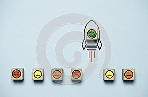 Smile face icon inside rocket missile rising from sad face icon for customer excellent experience evaluation feedback and survey