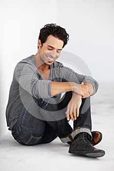 Smile, fashion and handsome young man by white wall with casual, cool and trendy outfit. Happy, confident and attractive