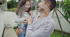 Smile, father and tickle child in garden, playing and having fun at home backyard. Funny kid, girl and dad laughing