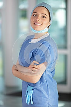 smile female nurse or surgeon wearing sterile blue suit photo