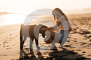 Smile Freedom and happiness chinese woman with dog on beach.