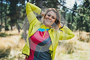 Smile girl exercising outdoors. Relaxing activity with stretch arms. Young fit woman doing stretching exercises training outside