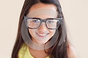 Smile, glasses and portrait of girl child with optical care, health and wellness in a studio. Happy, optometry and face