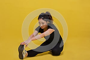 Smile happy Beautiful portrait young Asian woman stretching exercise workout on yellow background, fitness sport girl aerobic and