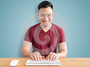 Smile and happy man in office desk.