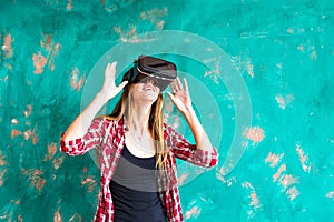 Smile happy woman getting experience using VR-headset glasses of virtual reality at home much gesticulating hands