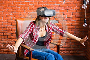 Smile happy woman getting experience using VR-headset glasses of virtual reality at home much gesticulating hands