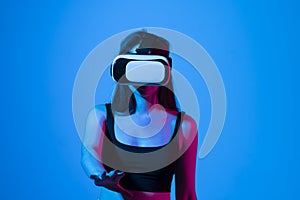 Smile happy woman getting experience using vr-headset glasses of virtual reality much gesticulating hands on gray