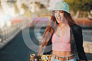 Smile, health and skateboard with woman in city for freedom, sports and relax lifestyle. Training, fitness and sunset